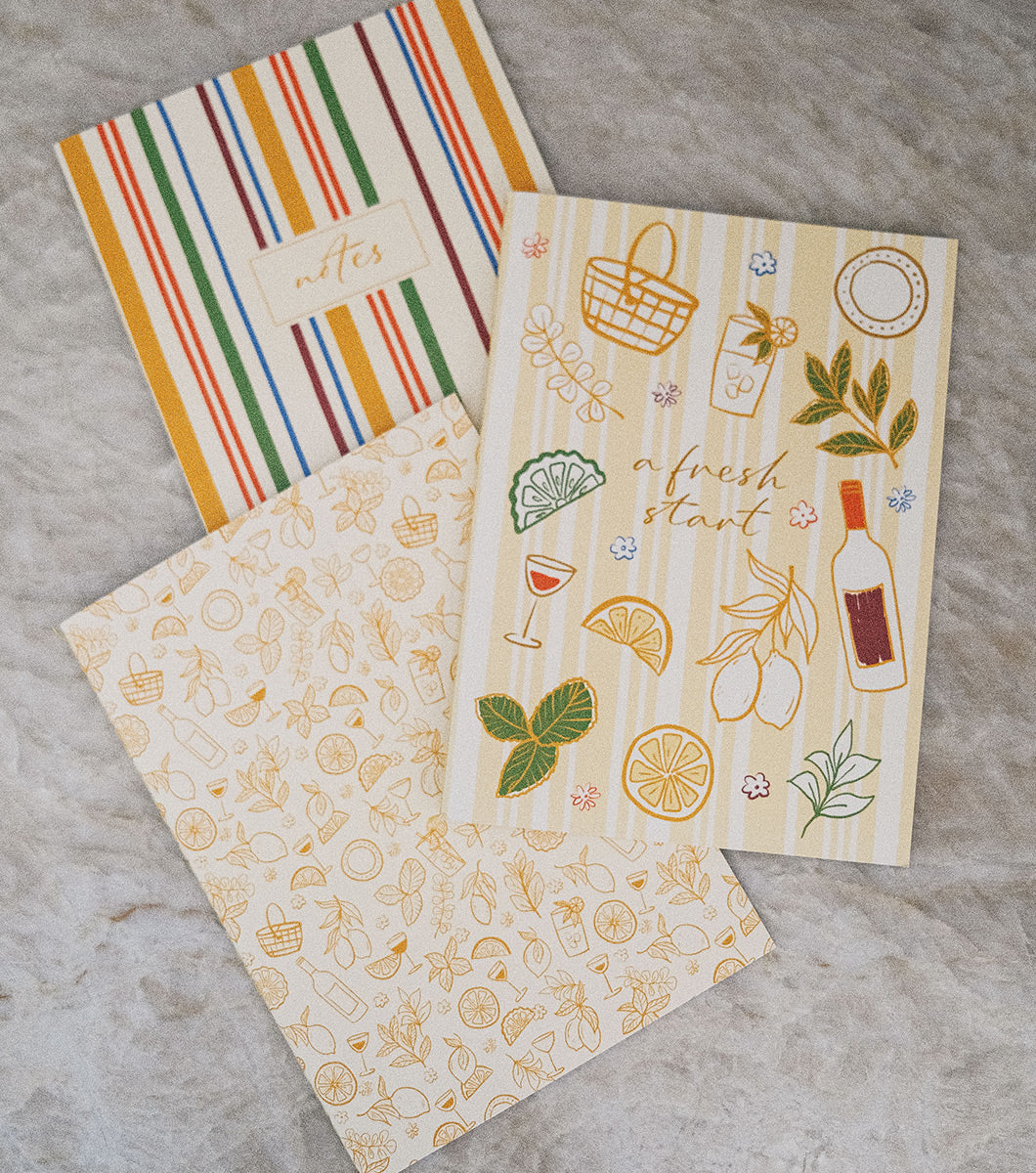 3 pack of journals featuring fresh picnic style designs of bold stripes and line drawings of food in a warm color palette