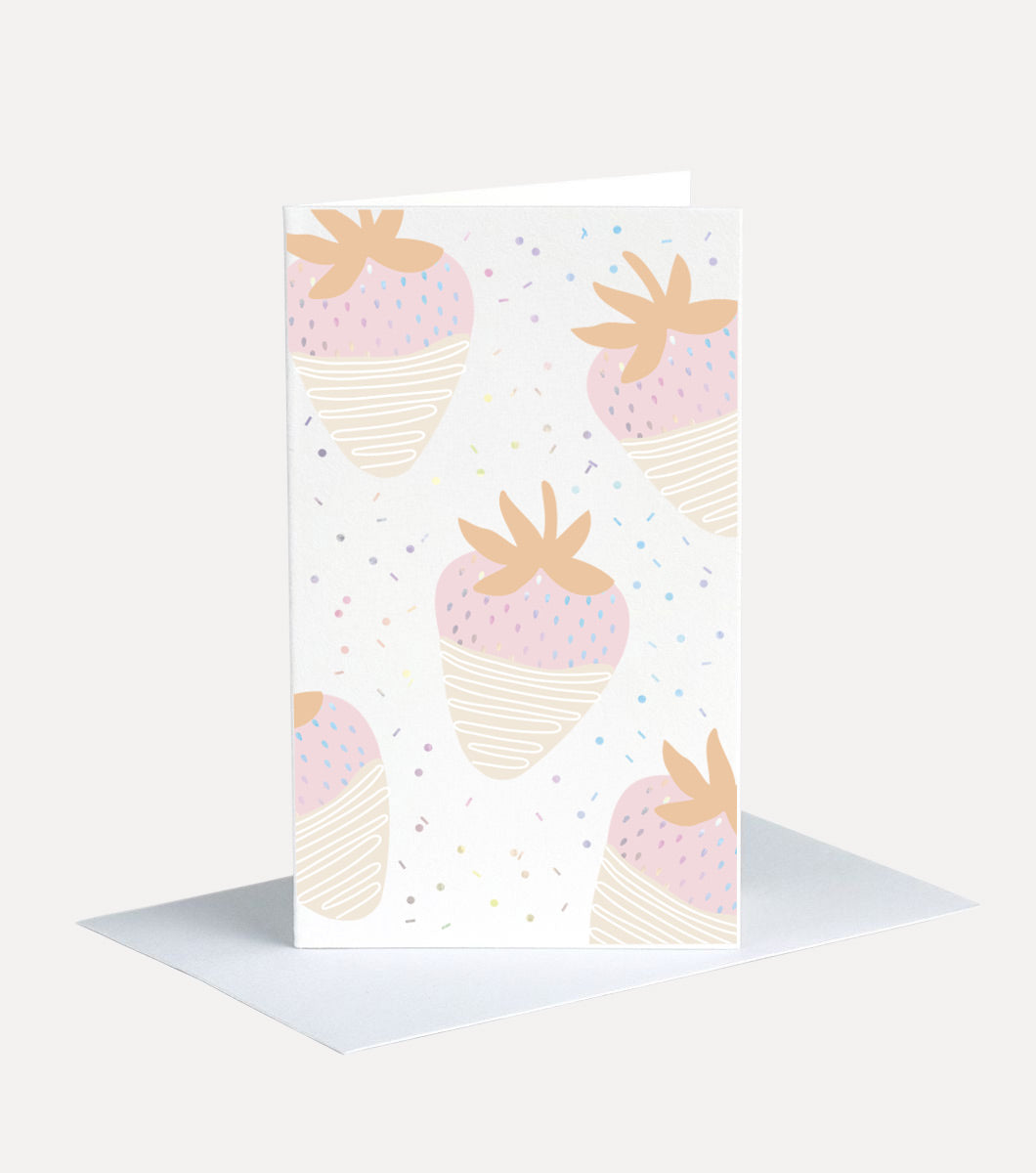 mini greeting card with design of repeating white chocolate covered strawberries. the strawberry seeds and background sprinkles are all holographic foil