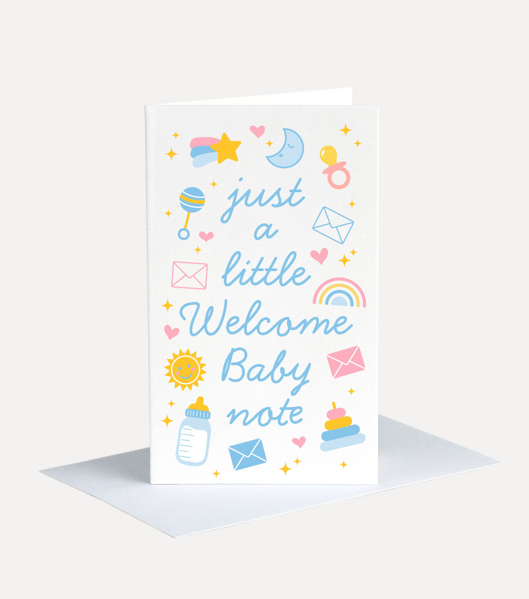 mini greeting card with message that says "just a litlte welcome baby note" with icons around it of baby items such as rattles, bottles, rainbows, suns and moons