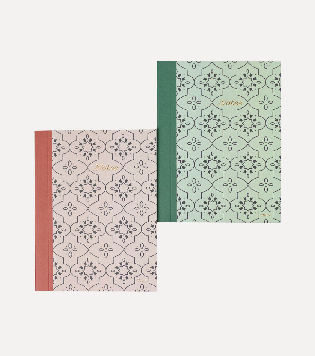 two pocket sized mini journals with moroccan tile motif, one in dusty pink and the other in aqua green. "Notes" is written on the front in gold foil