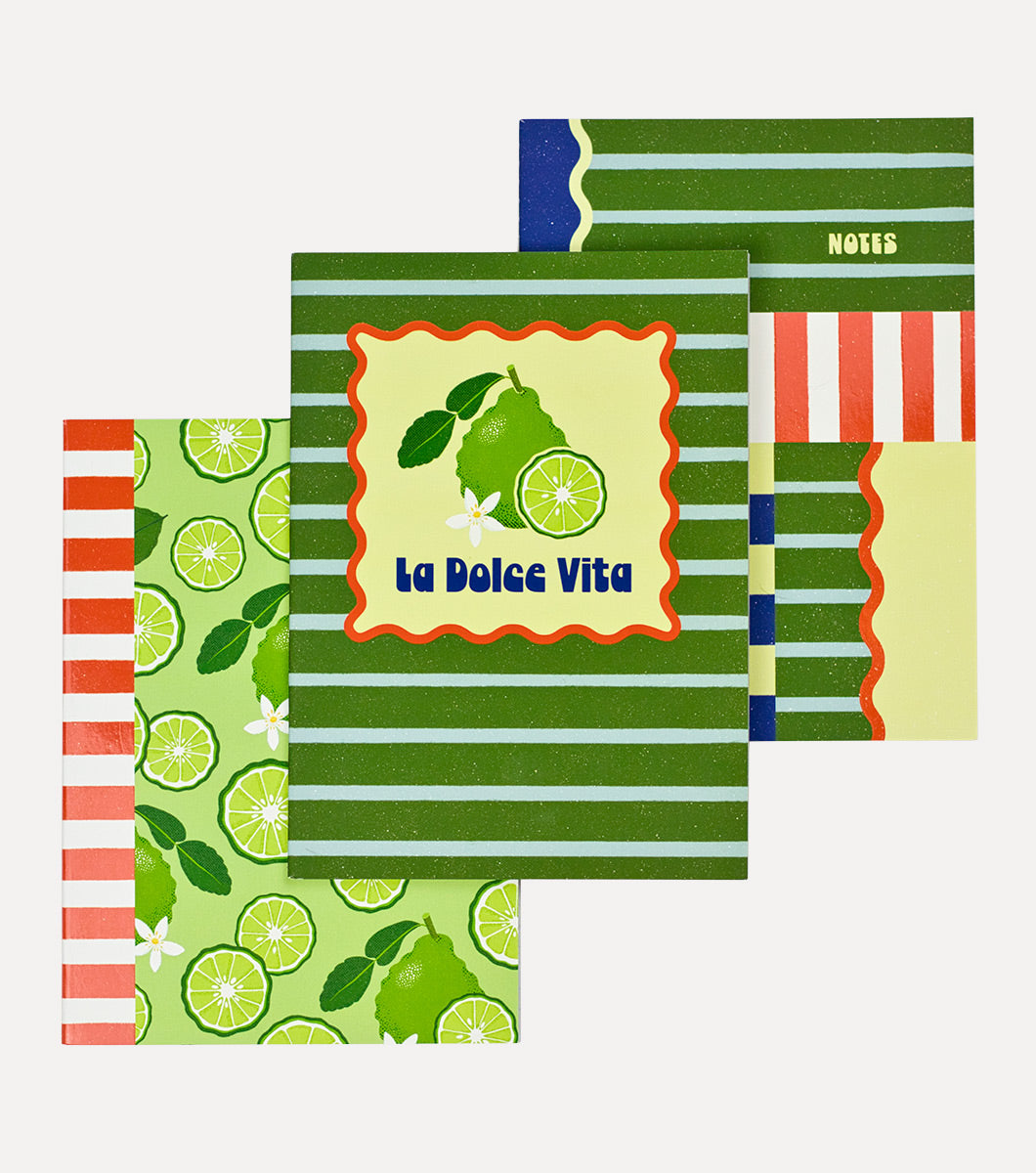 set of 3 journals with designs of bold stripes and sliced citrus designs of italian bergamots. Front of the main journal says "la dolce vita" 