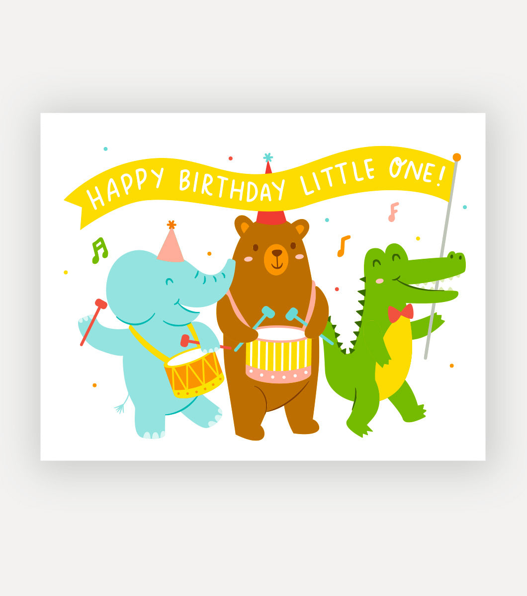 greeting card with elephant bear and allicagor on parade with drums and a banner that says "happy birthday little one!"