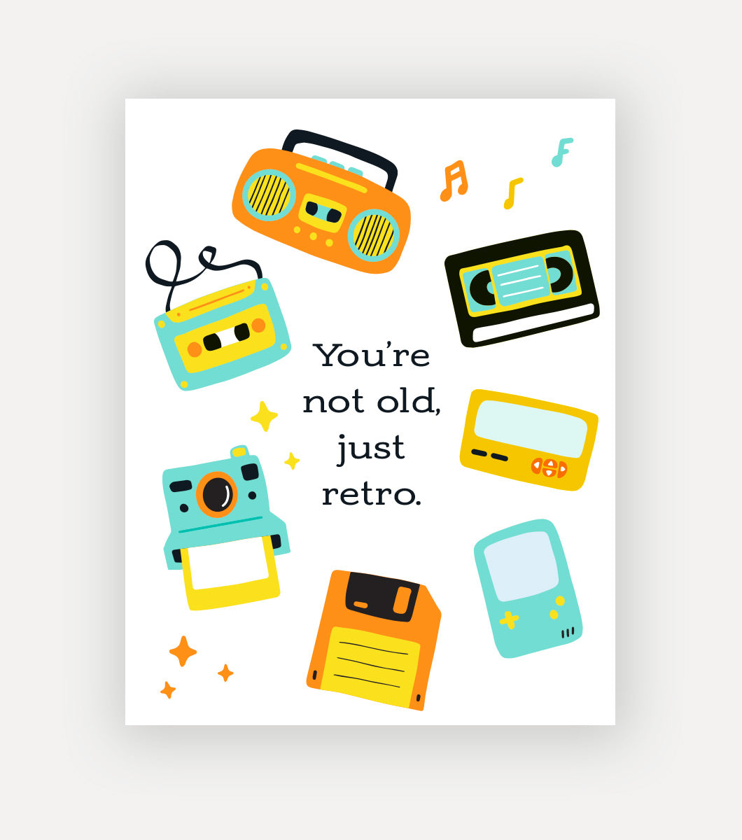 greeting card with vintage technology like VHS tapes, cassettes, film cameras and floppy disks with a sentiment that reads "You're not old, just retro"