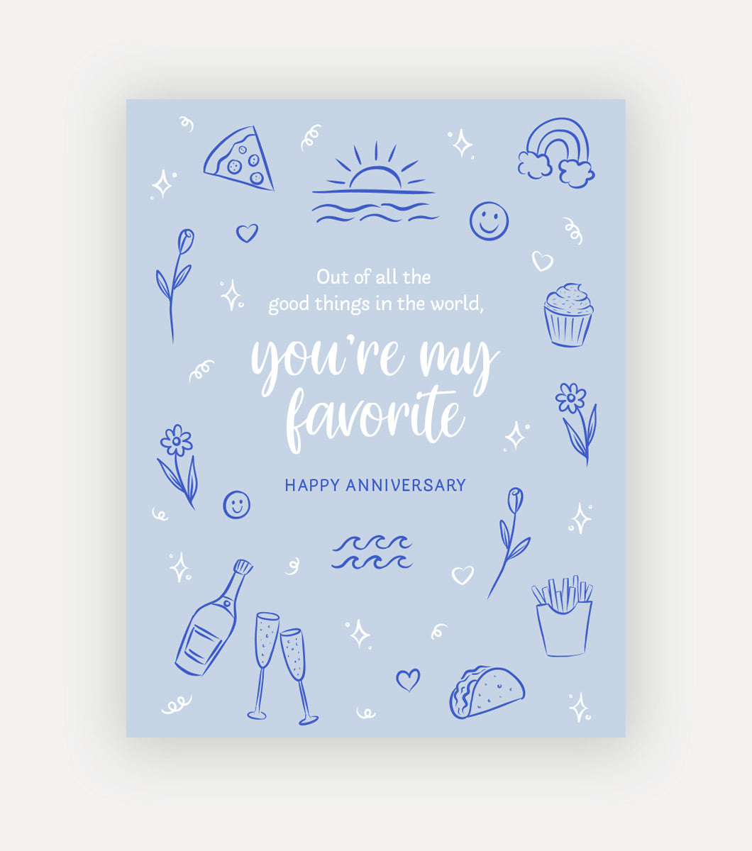 light blue greeting card with sentiment that reads "out of all the good things in the world, oyu're my favorite, Happy anniversary" Around the message in the middle is line drawings of pizza, cupcakes, flowers, champagne, tacos and rainbows