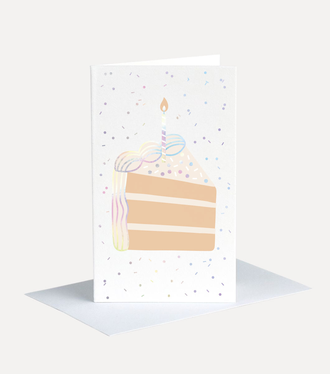 mini greeting card with a design that features a slice of layered cake with a birthday candle. cake and background features holographic sprinkles