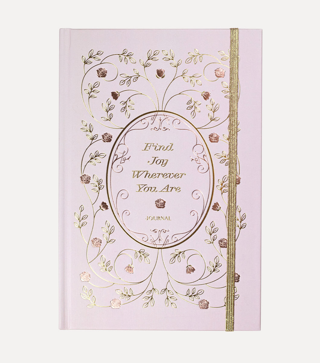 blush pink colored journal with vintage rose design in gold foil and rose gold foil. Front of the journal says "find joy wherever you are" 