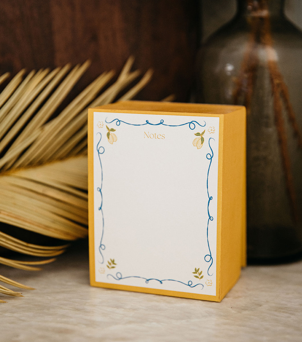 chunky color block note pad with dark yellow painted edges and a blue lined border