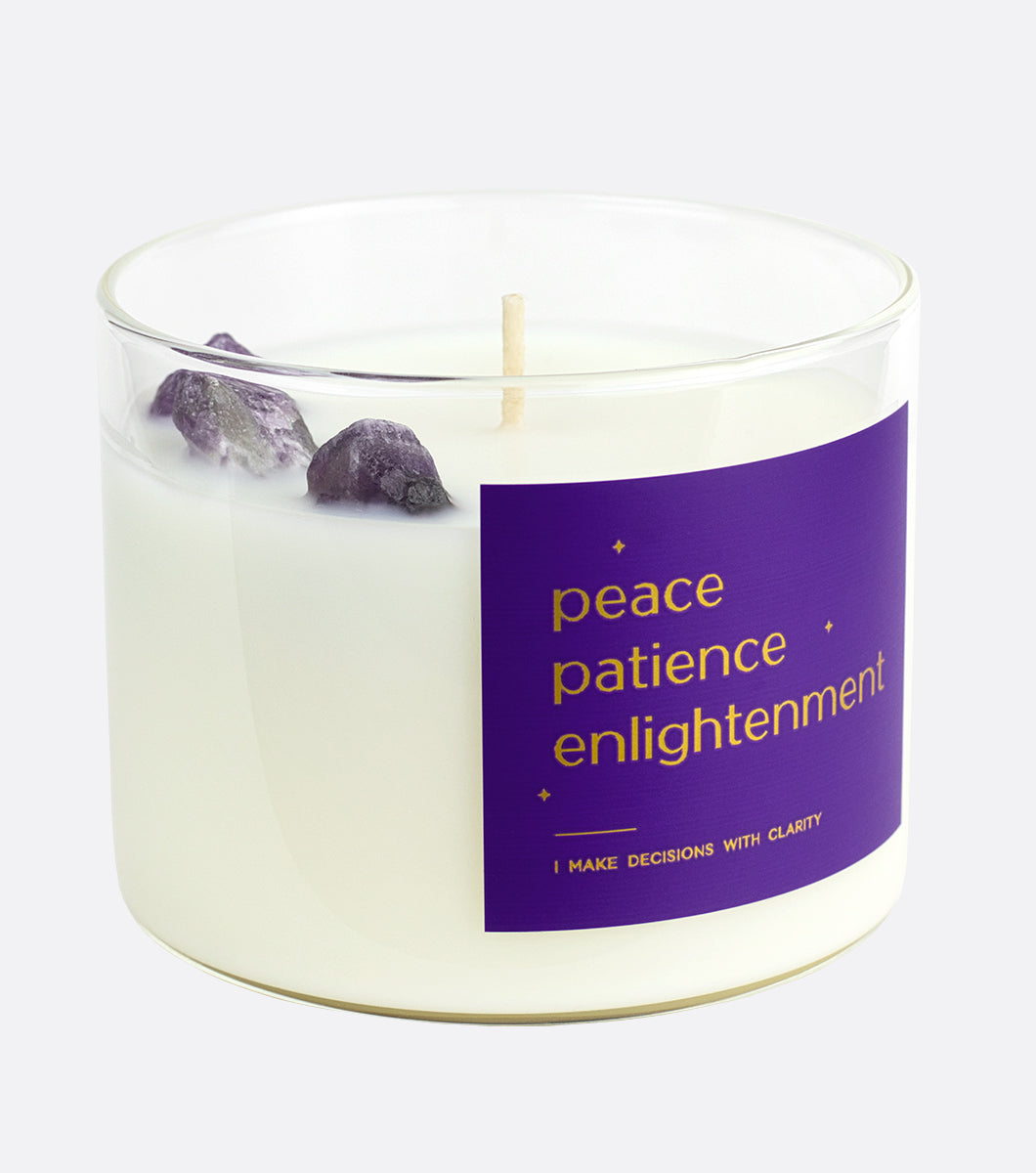 crystal candle with three amethyst crystals hidden inside, purple candle label says peace patience enlightenment