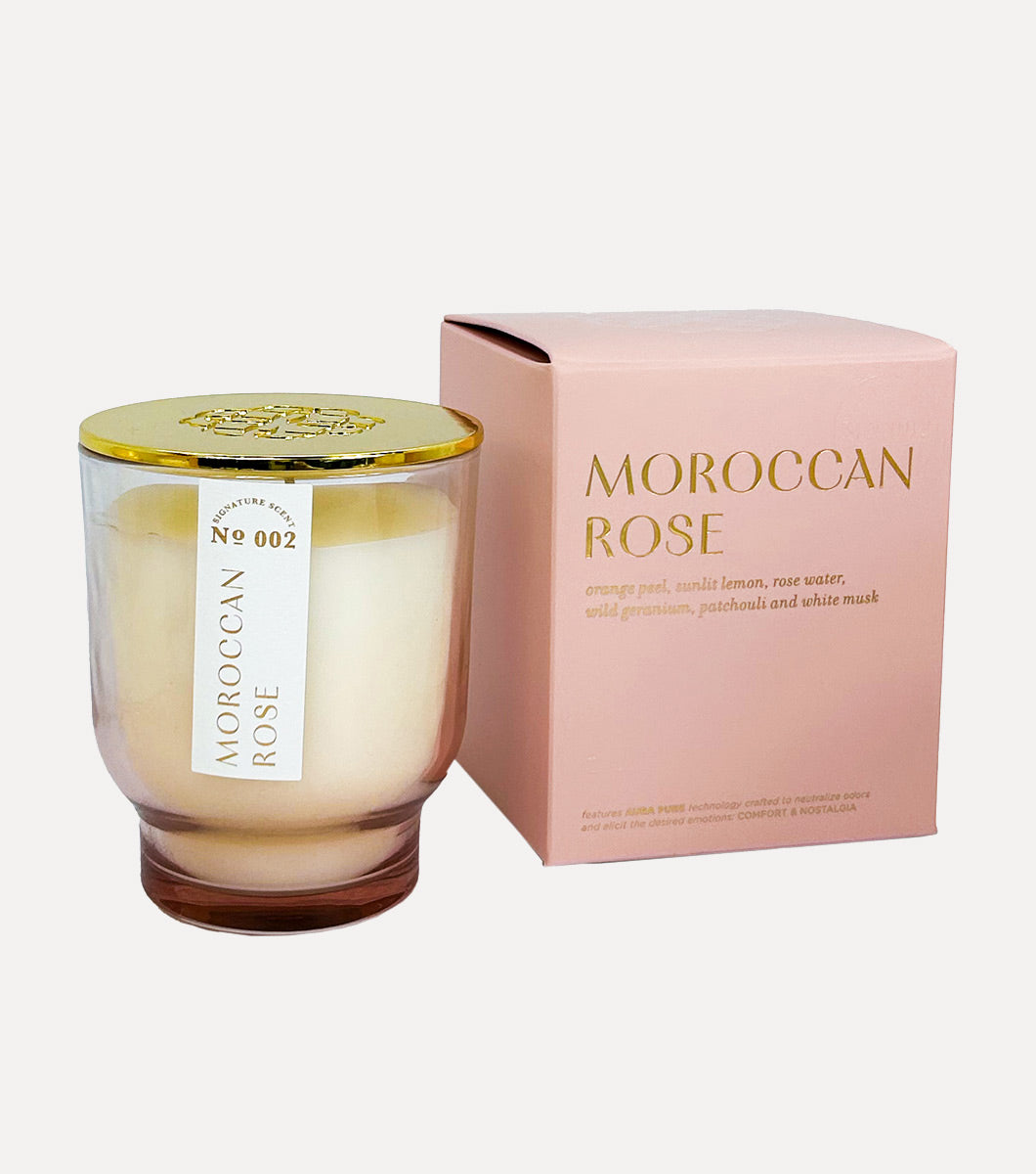 small pink moroccan rose scented candle pictured next to included pink gift box