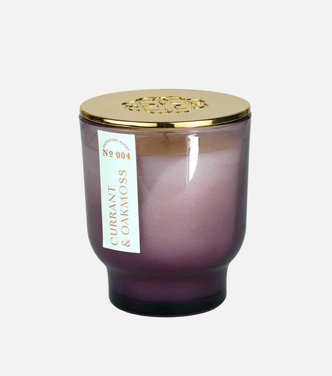 small purple currant and oakmoss scented hand poured candle with gold lid