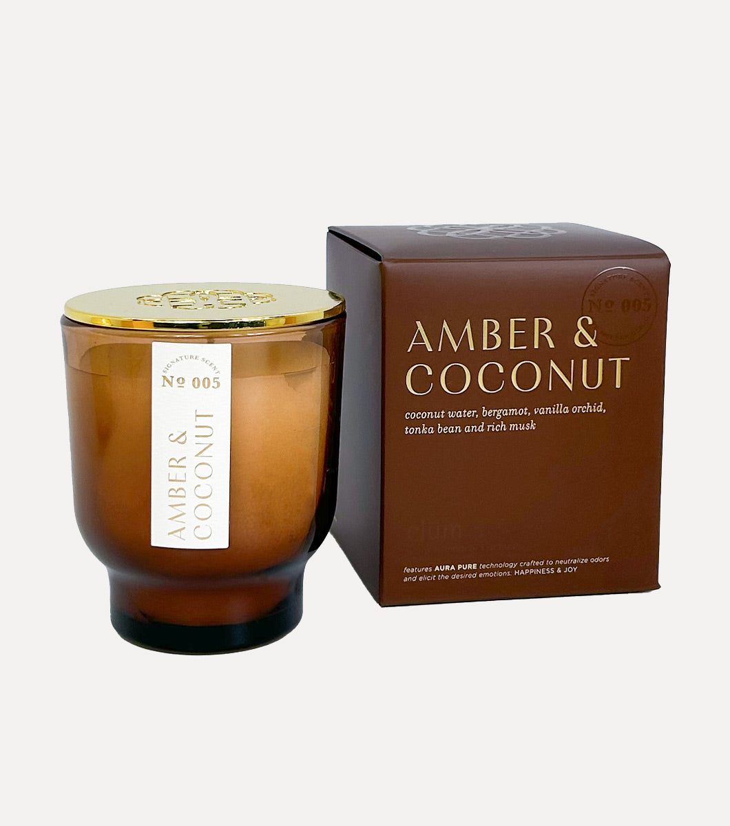 small amber and coconut scented candle pictured next to included gift box