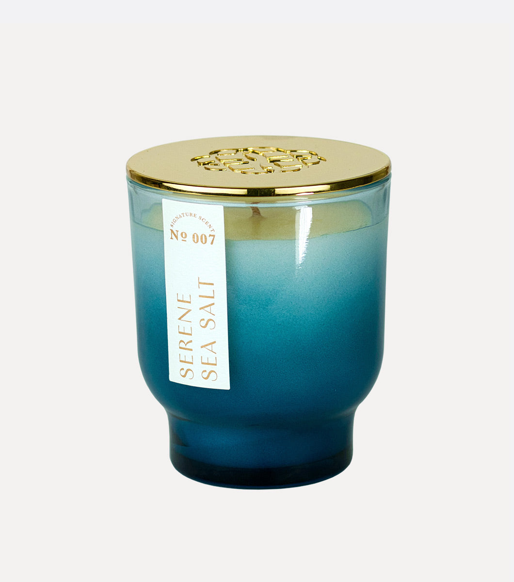 small blue serene sea salt scented hand poured soy wax candle with gold lid