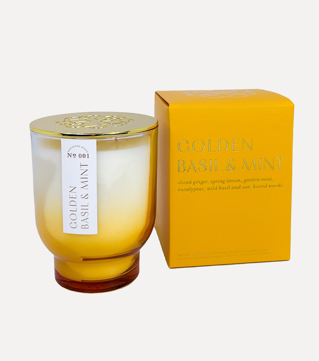 golden basil and mint scented candle pictured next to included yellow gift box