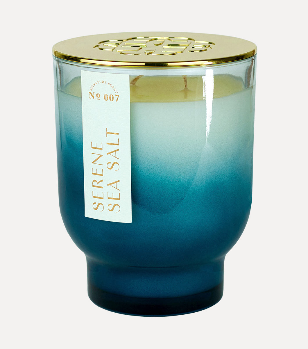 large blue tapered sea salt scented hand poured soy wax candle with gold lid