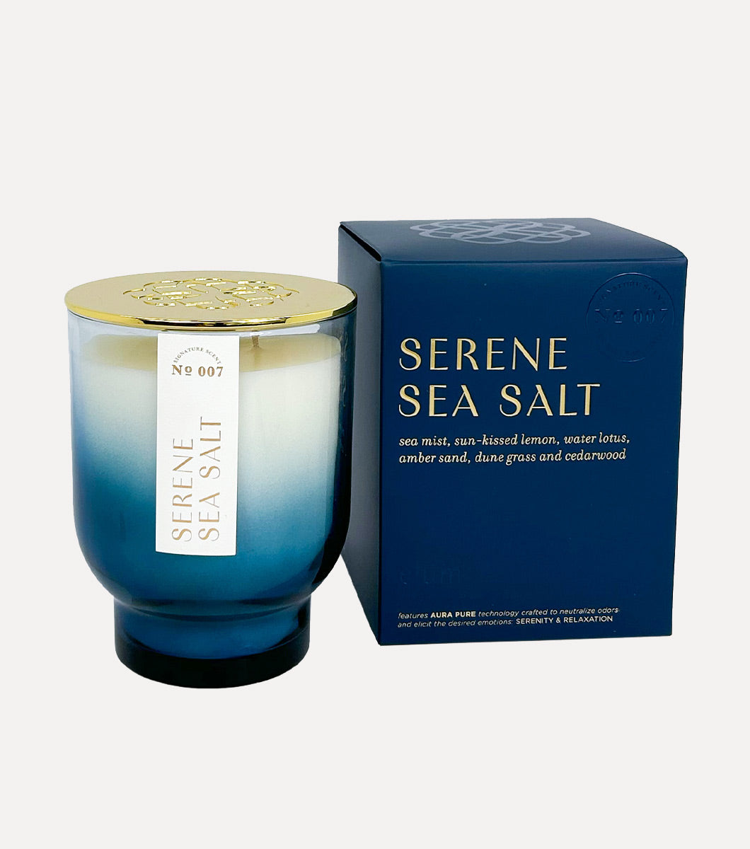 large serene sea salt scented candle pictured next to included blue gift box