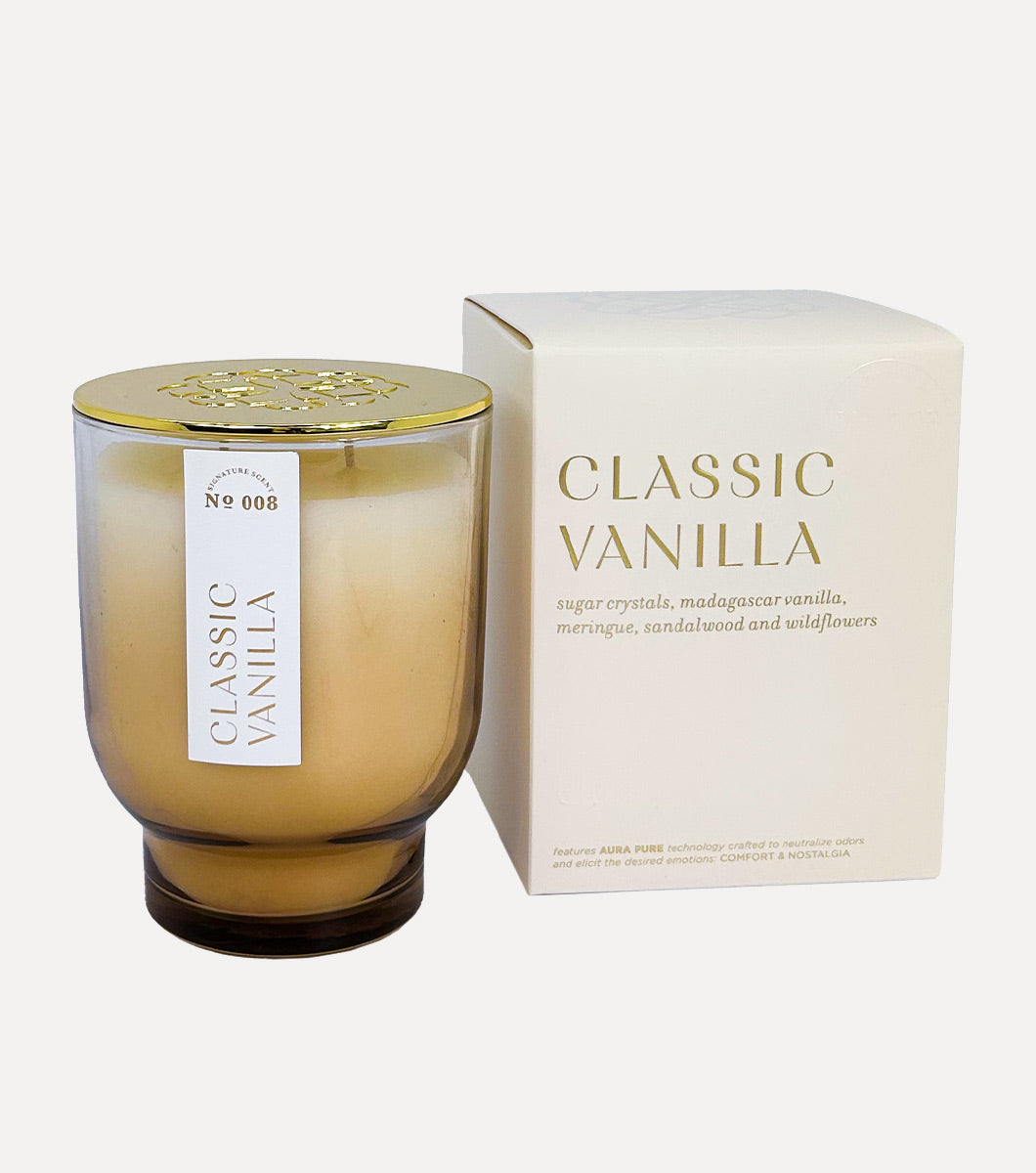 large classic vanilla scented candle pictured next to included cream colored gift box