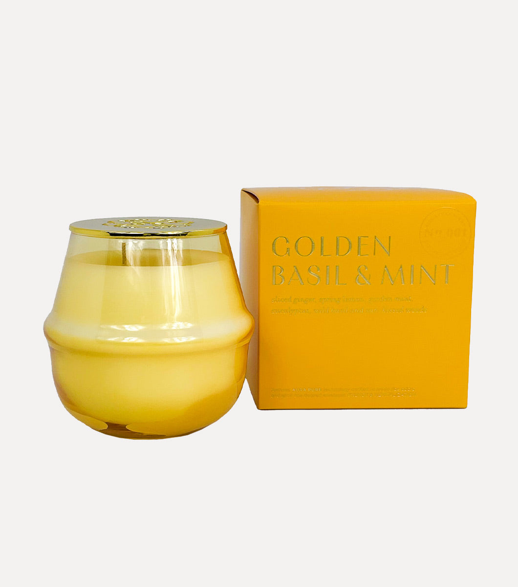 round yellow golden basil and mint scented candle pictured next to included gift box