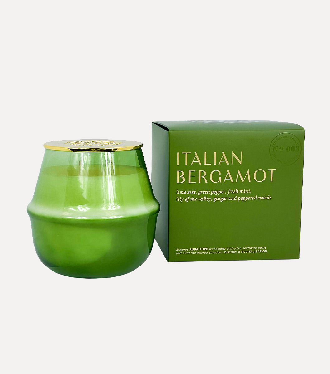 large round green italian bergamot scented candle pictured next to included green gift box