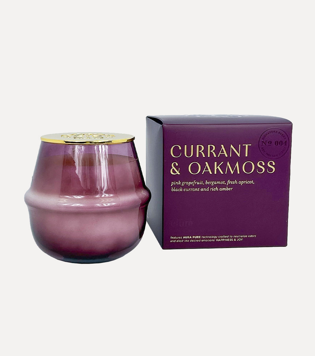 large purple currant and oakmoss scented candle pictured with included purple gift box