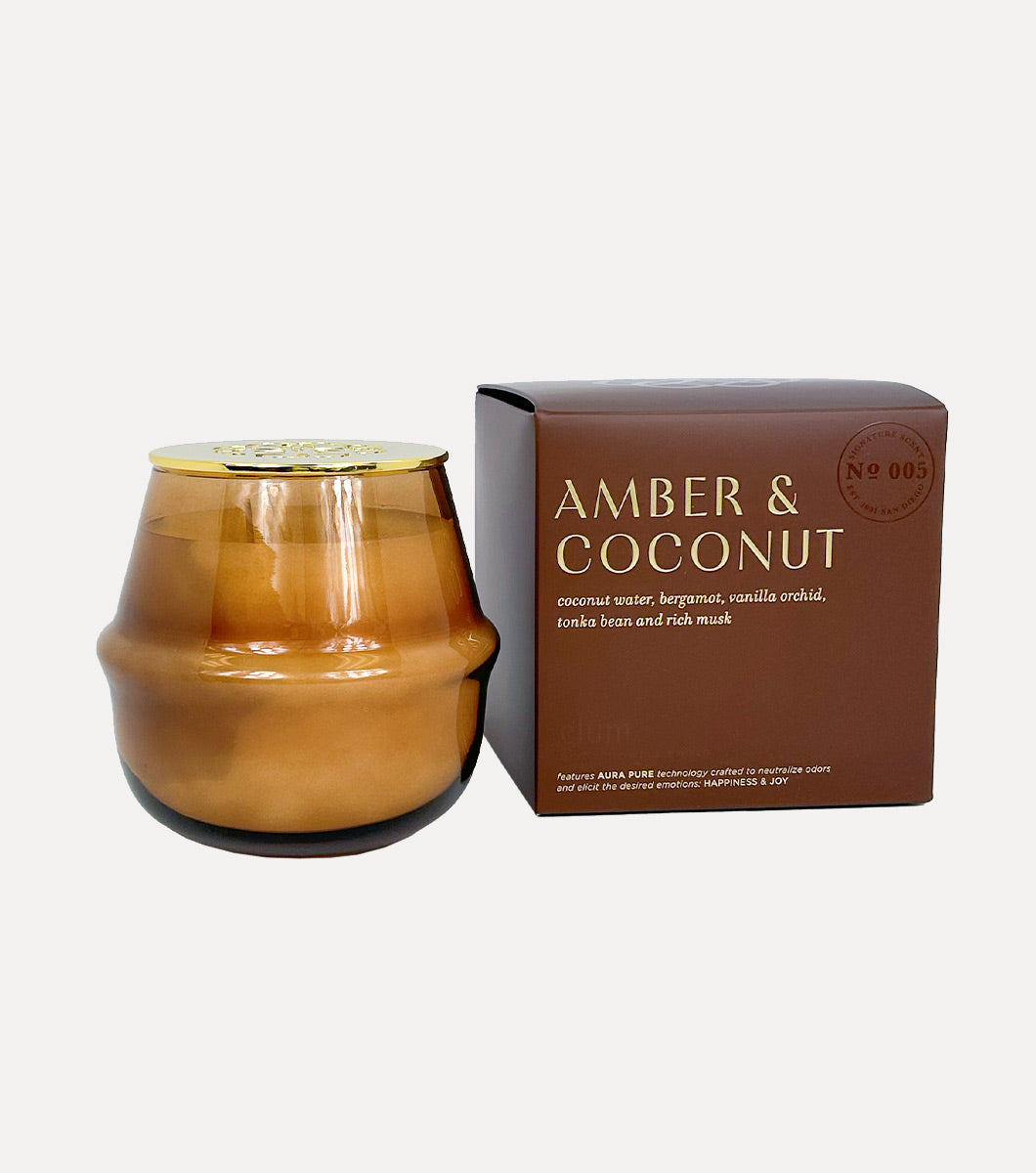 amber and coconut scented candle pictured next to included brown gift box