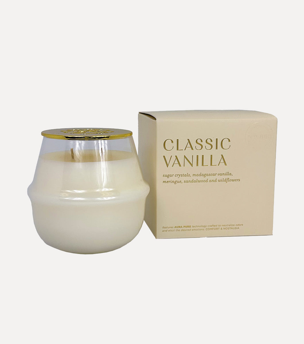 large round classic vanilla scented candle pictured next to cream colored gift box