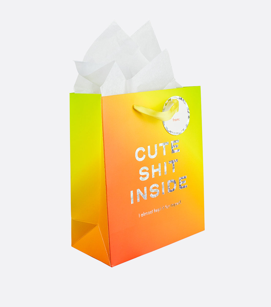 colorful medium sized gift bag with gradient design and "cute shit inside" written on the front in shattered holographic