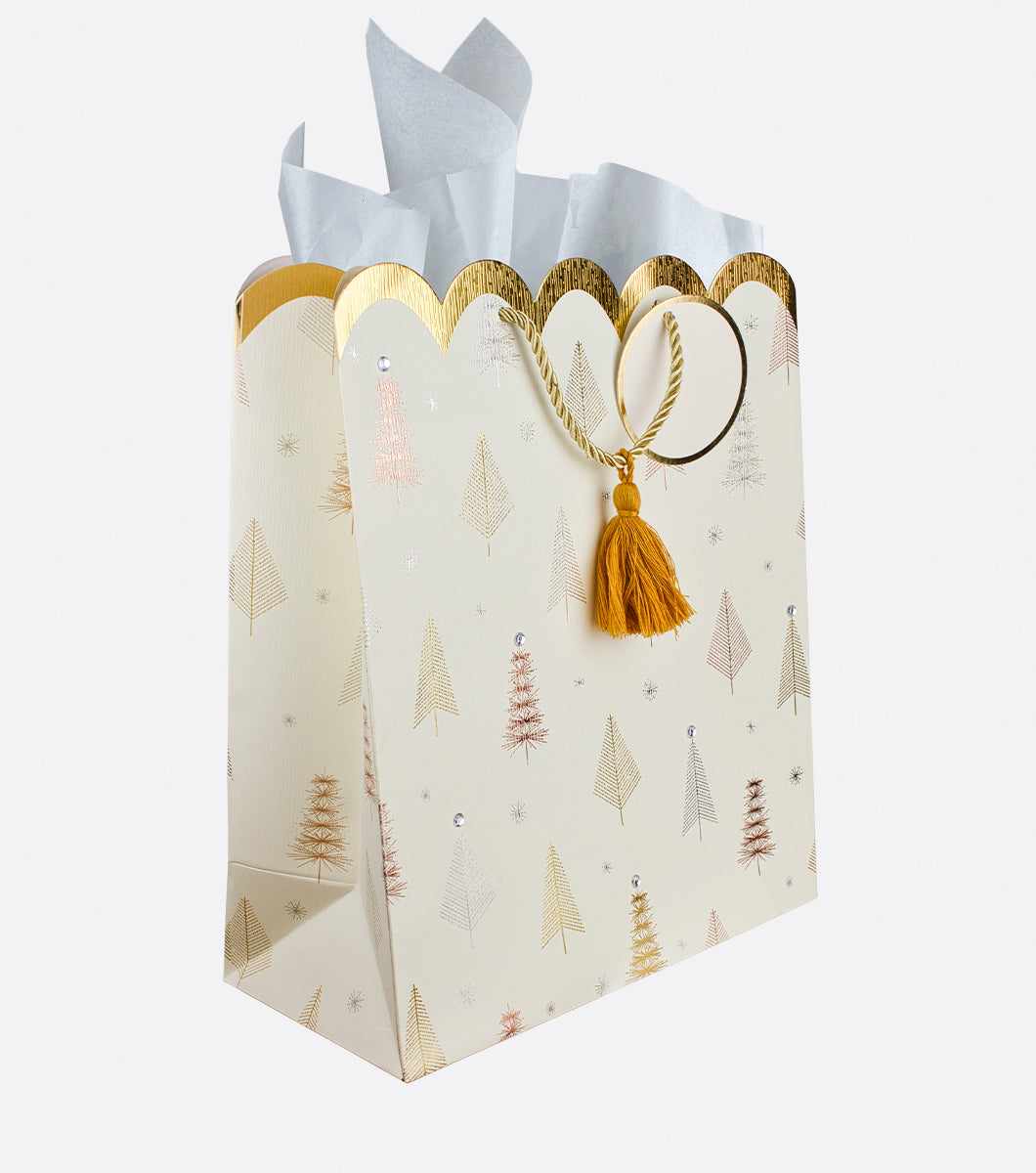 ivory colored Holiday gift bag with gold silver and rose gold foil line drawings of christmas trees and rinestones with a decorative tassel 