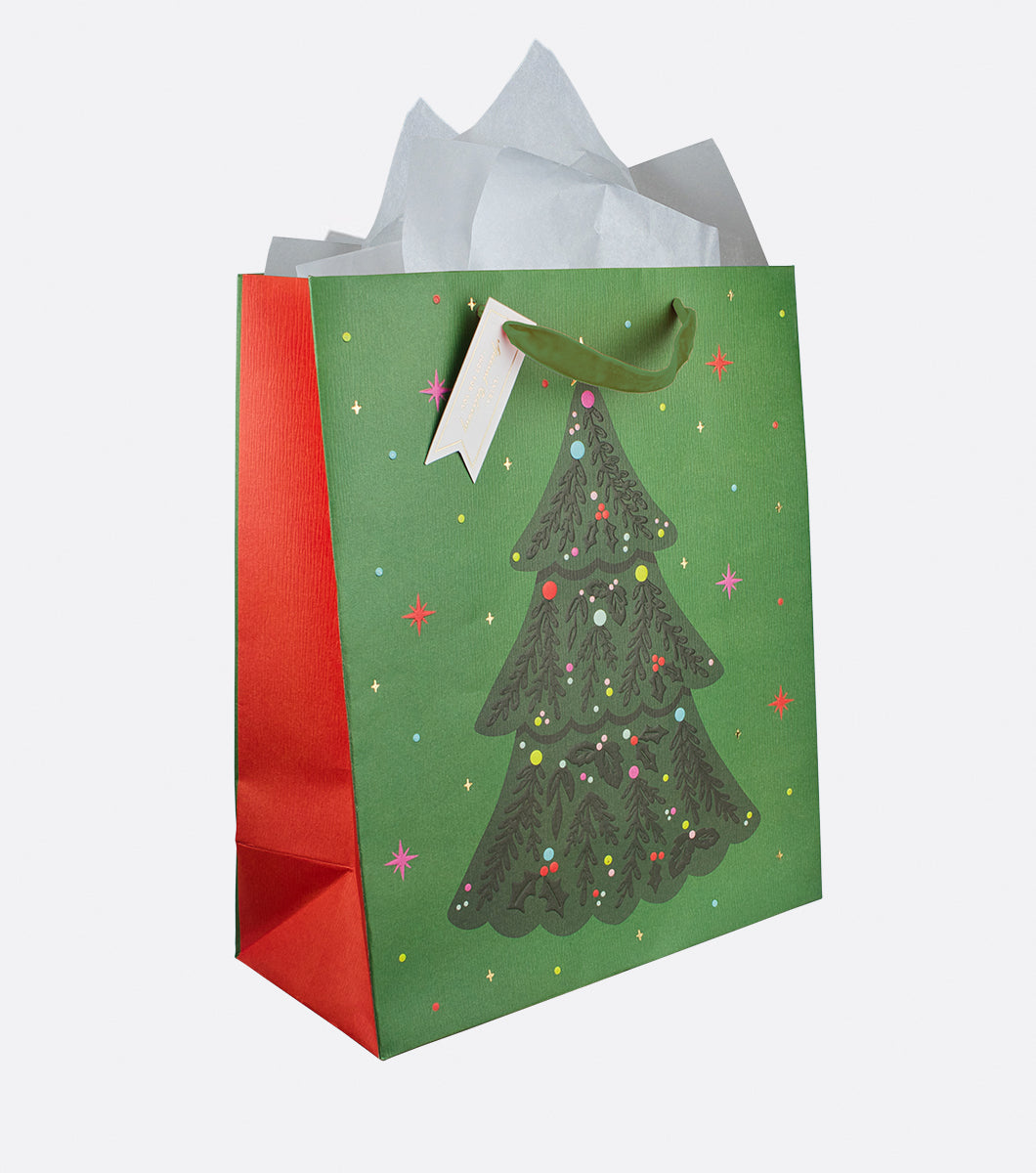 Green and red  gift bag with a colorful christmas tree design and a gold foil hangtag 