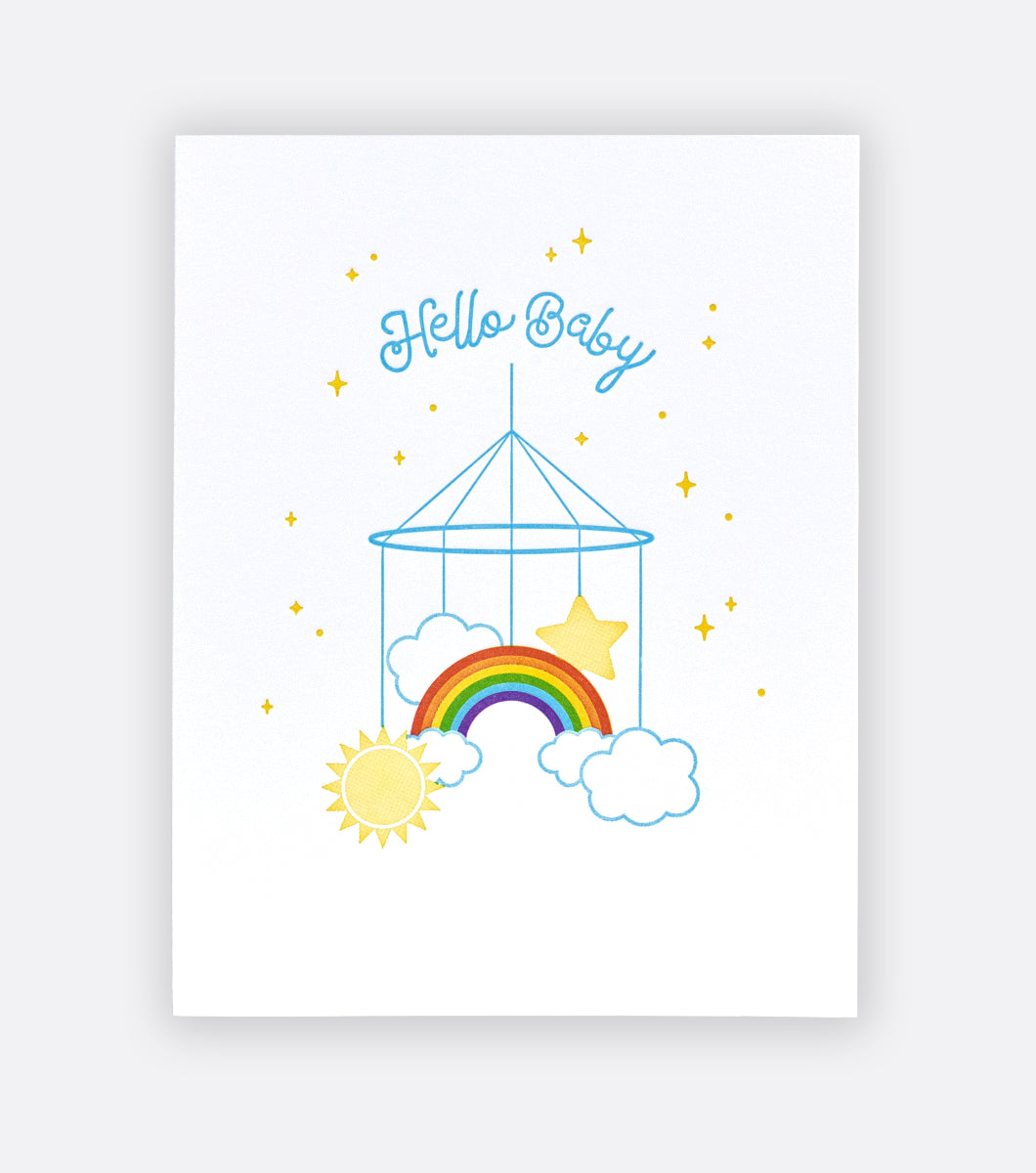 rainbow baby mobile letterpress greeting card featuring a rainbow mobile and message saying Hello Baby