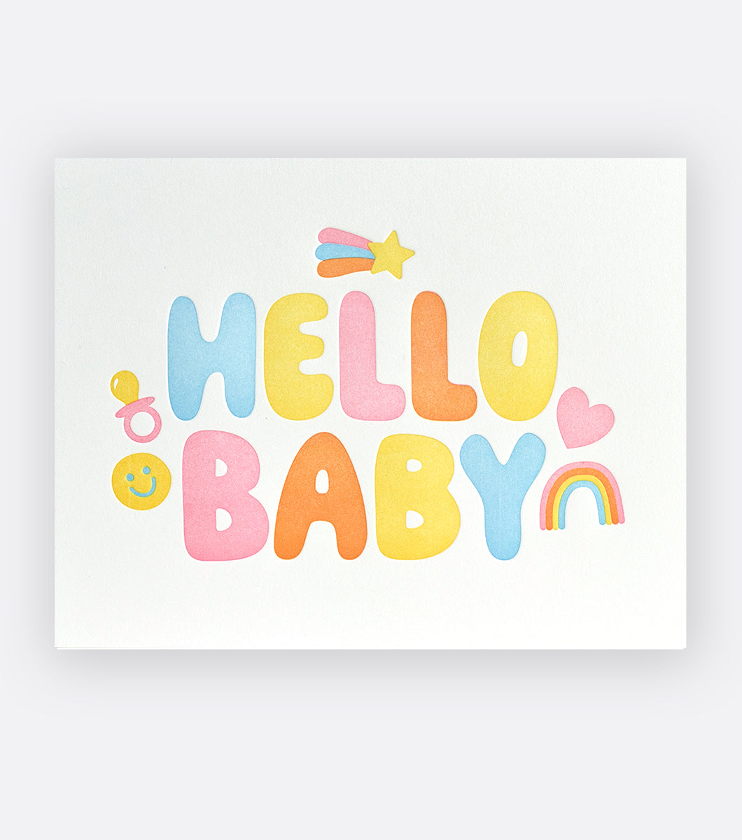 greeting card with sentiment saying "hello baby" in bubble letters with icons of happy faces, pacifiers, shooting stars, hearts and rainbows