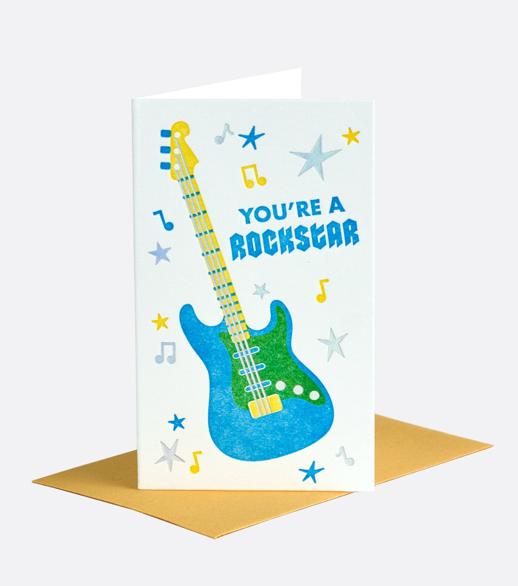 greeting card with electric guitar and music notes and a sentiment that reads "you're a rockstar"