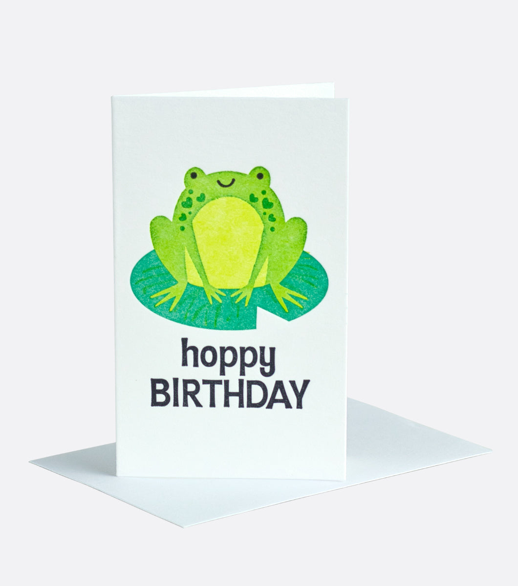 miniature greeting card featuring a frog sitting on a lily pad with a sentiment that says "Hoppy Birthday" 