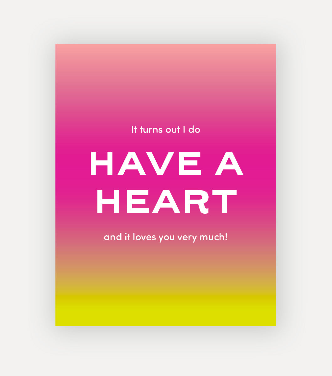 sassy letterpress greeting card with a sentiment that says "it turns out i do have a heart and it loves you very much!" reversed out in white on a background of pink and yellow linear gradient