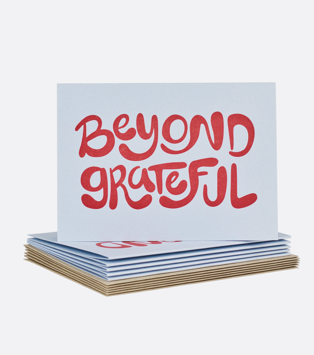 stack of beyond grateful letterpress boxed notes with one card standing on top message on front of card says beyond grateful in bubbly letters