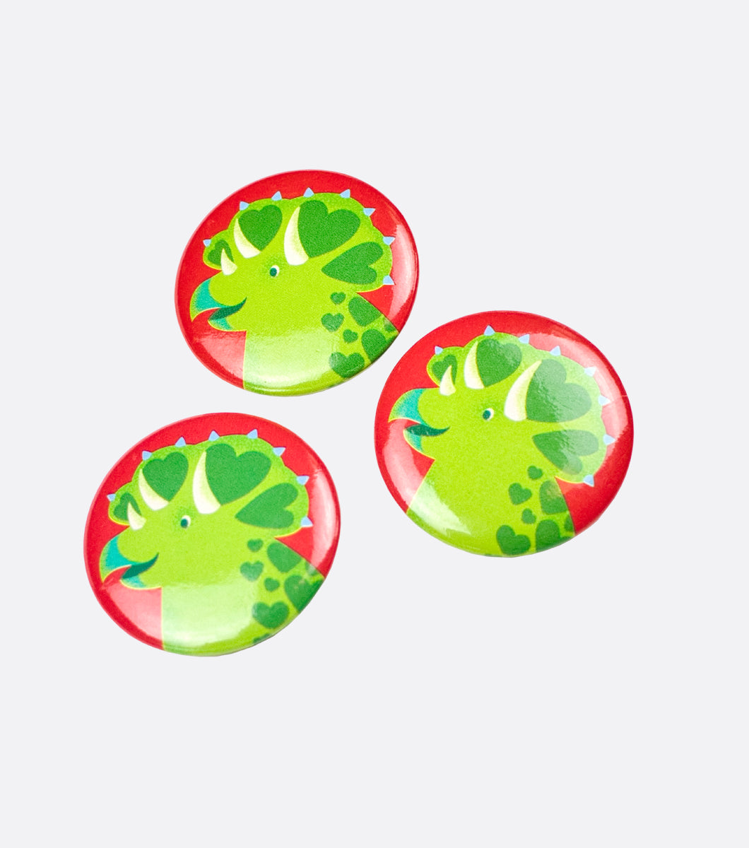 three dinosaur buttons